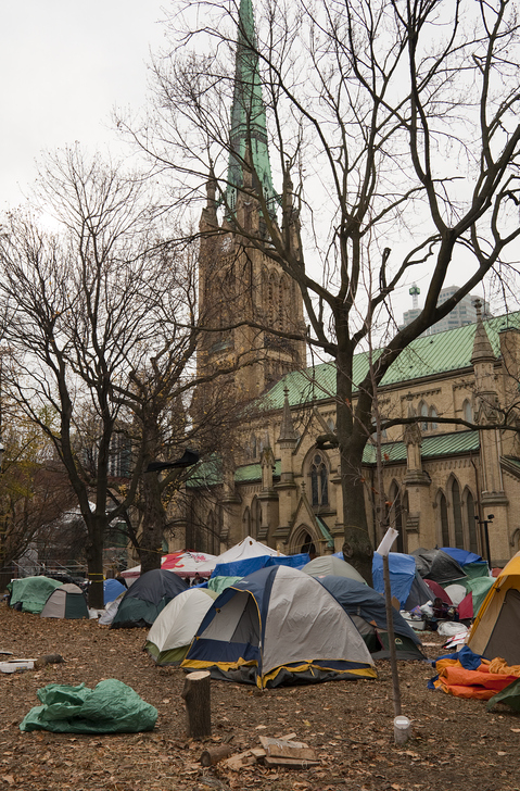 Toronto, Canada - November 22, 2011: Tents in St. James Park in downtown Toronto during Occupy Toronto protests with St. James Church in the background on the last day of the protests before the park was cleared of the demonstrators.